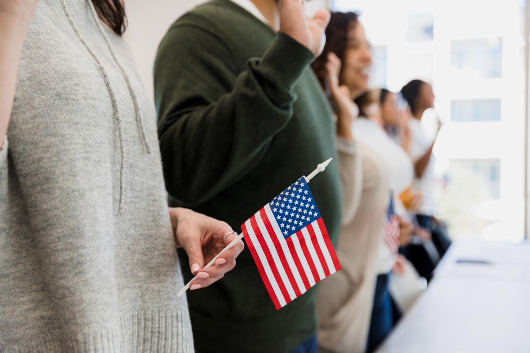 people raising hands to recite a pledge